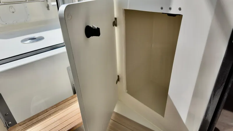 Slide: The Image of Open storage compartment in 2025 Bayliner Trophy 23 Pilothouse boat interior. - 23