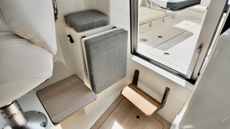 Slide: The Image of 2025 Bayliner Trophy 23 Pilothouse interior seating and step detail. - 26