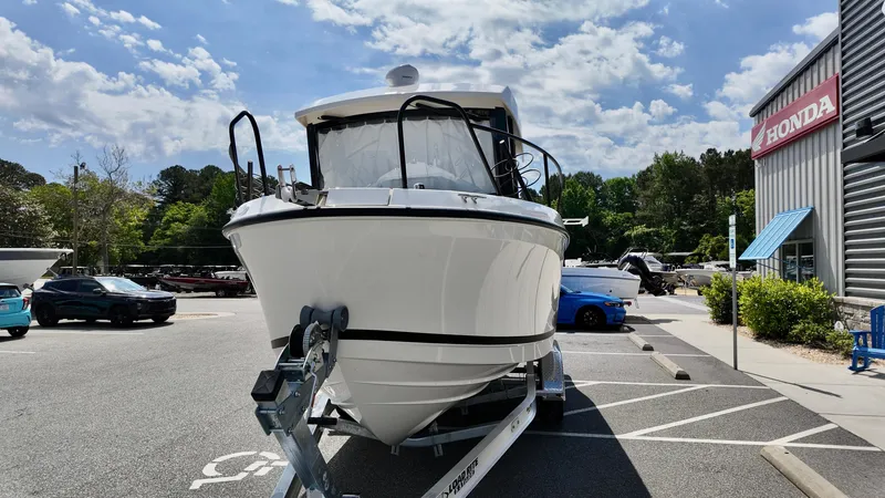Slide: The Image of 2025 Bayliner Trophy 23 Pilothouse boat on trailer in parking lot, sunny day. - 5