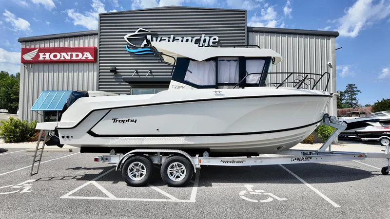 Slide: The Image of 2025 Bayliner Trophy 23 Pilothouse boat on trailer, parked outside dealership. - 6