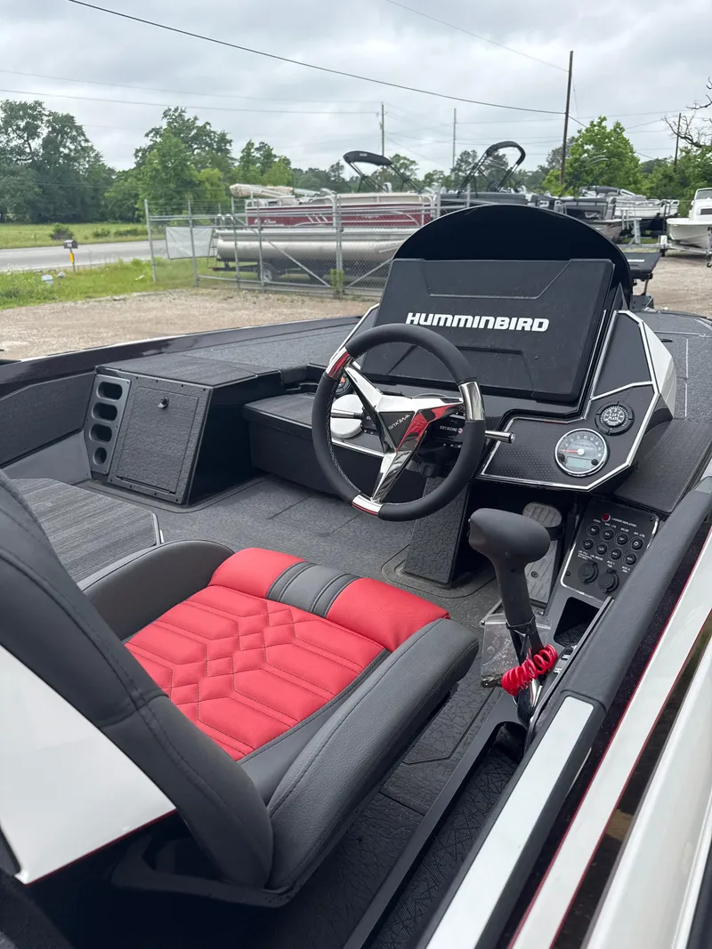 Slide: The Image of 2025 Vexus VXS20 boat interior with red and black seating, steering wheel, and Humminbird electronics. - 10