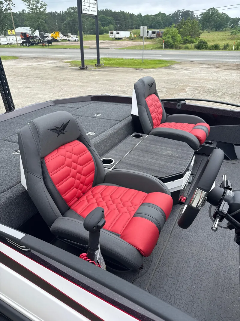 Slide: The Image of 2025 Vexus VXS20 boat interior with red and gray seats, steering wheel, and console. - 12