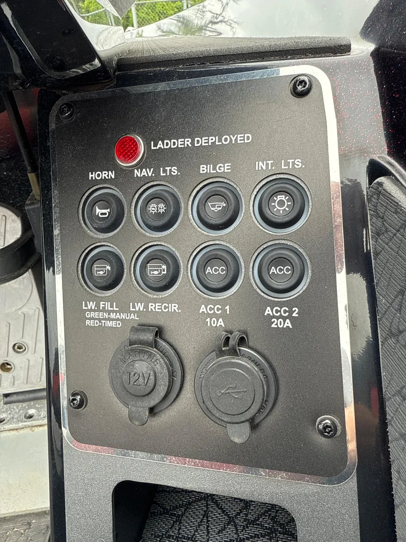 Slide: The Image of Control panel of 2025 Vexus VXS20 boat with various switches and ports. - 13