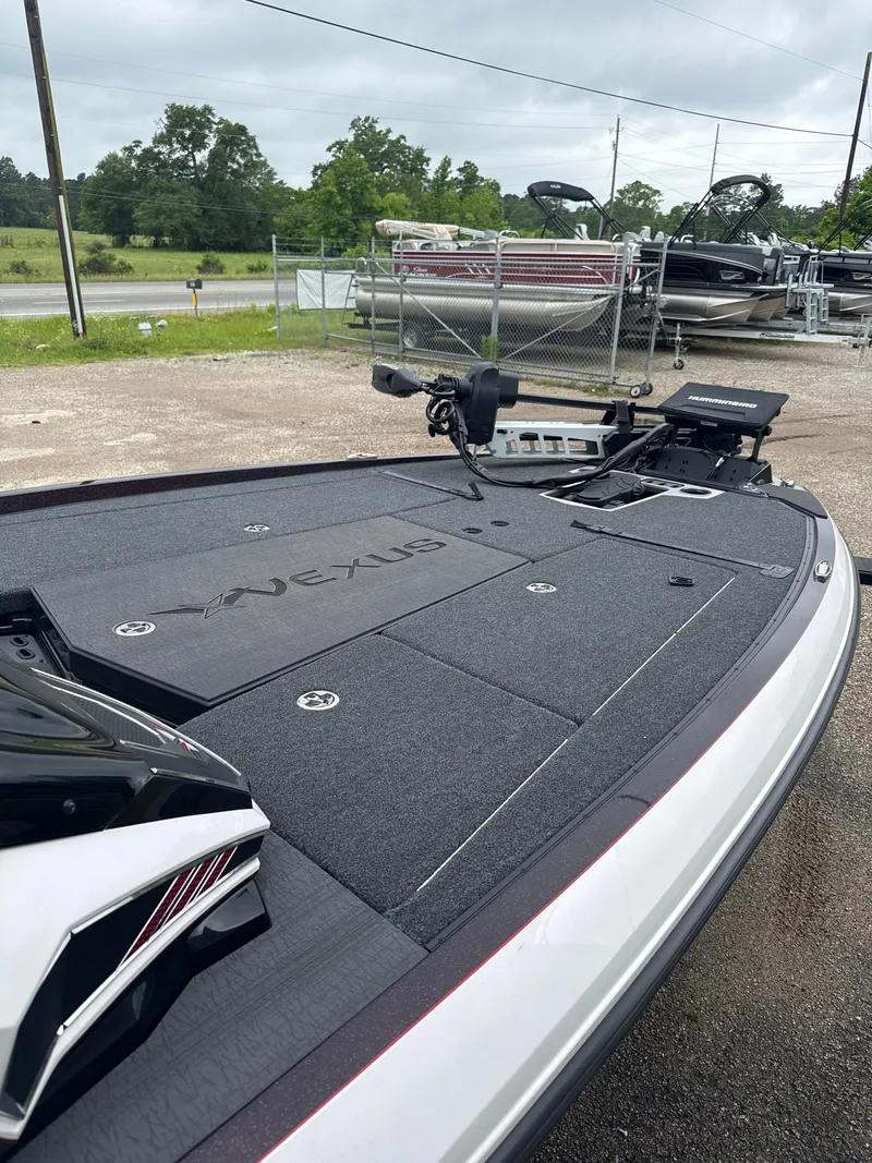 Slide: The Image of 2025 Vexus VXS20 boat deck with advanced fishing equipment, parked outdoors. - 18