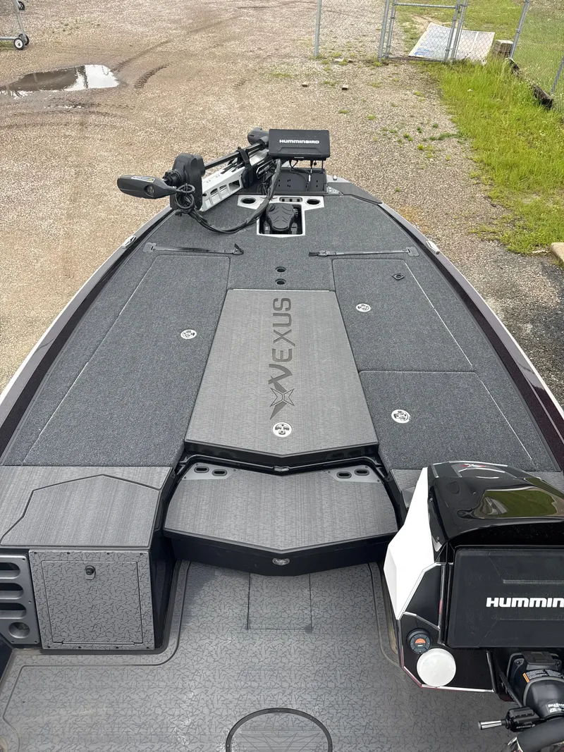 Slide: The Image of 2025 Vexus VXS20 boat deck with Humminbird electronics, parked on gravel. - 24