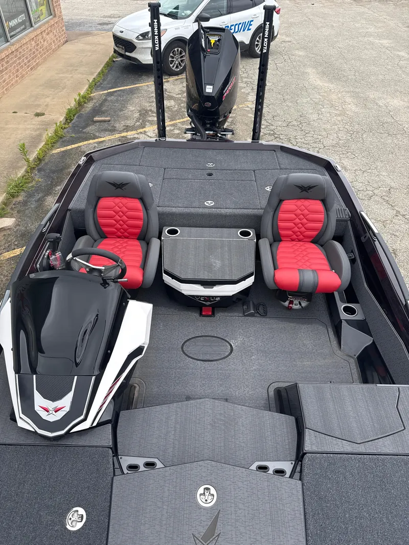 Slide: The Image of 2025 Vexus VXS20 boat interior with red and gray seating, steering console, and motor. - 25