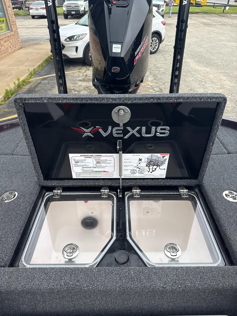Slide: The Image of 2025 Vexus VXS20 boat with open storage compartments and visible engine. - 32