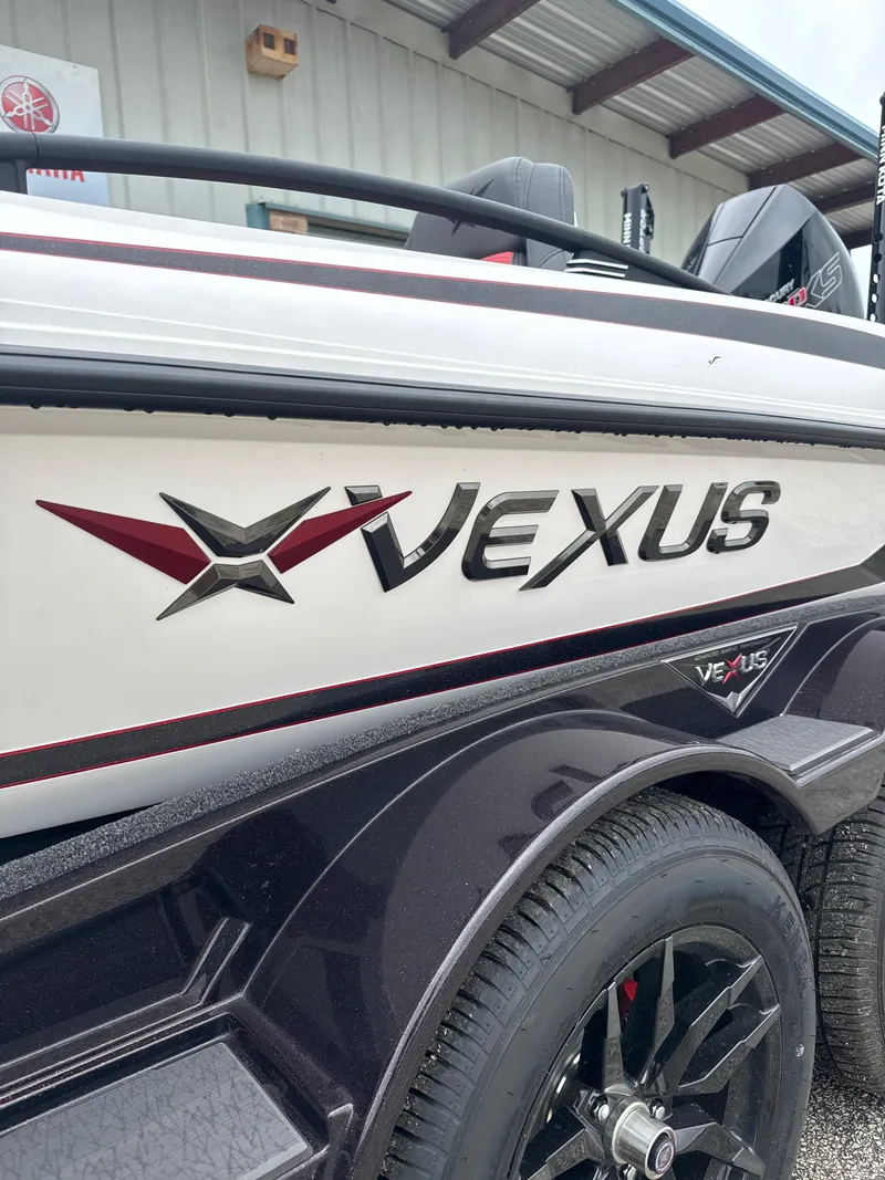 Slide: The Image of 2025 Vexus VXS20 boat with sleek design and logo, parked near a building. - 5