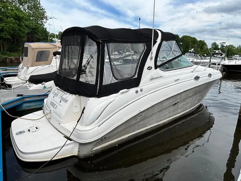 The Image of 2007 Sea Ray 280 Sundancer boat docked in a marina with a black canopy. - 0