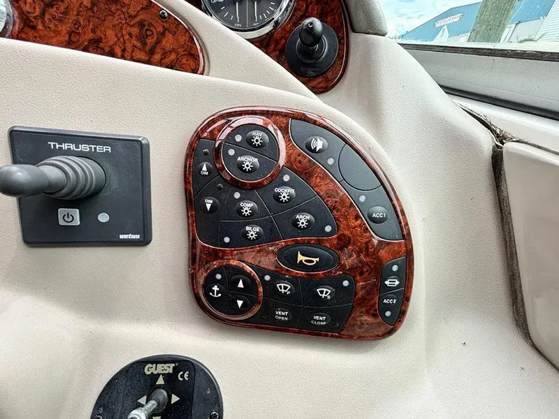 Slide: The Image of Control panel of a 2007 Sea Ray 280 Sundancer boat with various switches and thruster control. - 11