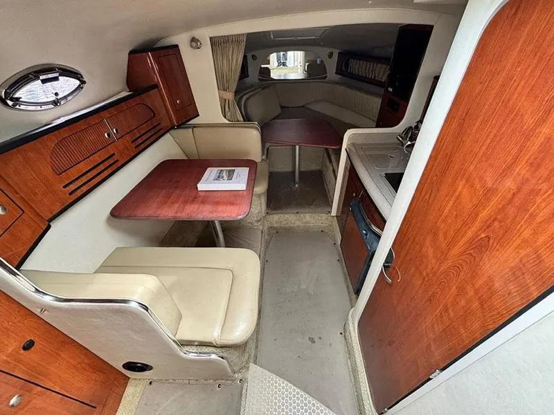 Slide: The Image of Interior of 2007 Sea Ray 280 Sundancer with seating, table, and kitchenette. - 13