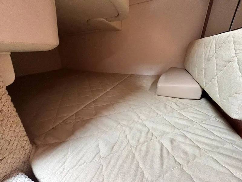 Slide: The Image of Interior cabin of 2007 Sea Ray 280 Sundancer with beige quilted bedding. - 18