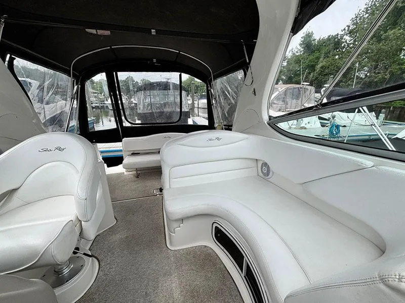 Slide: The Image of 2007 Sea Ray 280 Sundancer interior with white seating and spacious cabin design. - 20