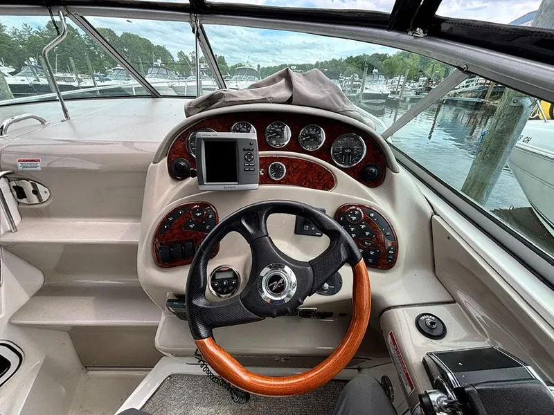 Slide: The Image of 2007 Sea Ray 280 Sundancer helm with wood-accented steering wheel and instrument panel. - 3