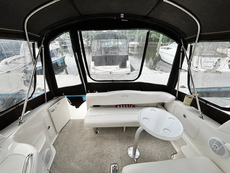 Slide: The Image of 2007 Sea Ray 280 Sundancer interior with seating and table, docked at marina. - 5