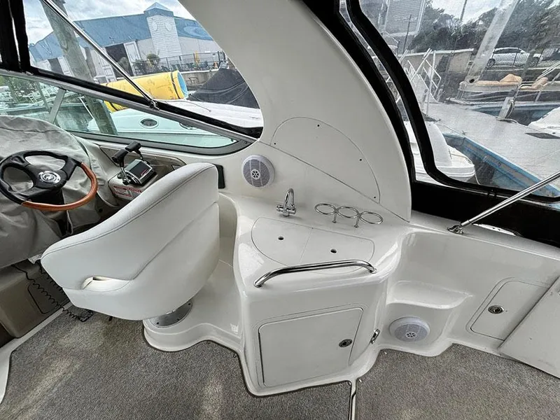 Slide: The Image of 2007 Sea Ray 280 Sundancer cockpit with helm, seating, and sink area. - 7