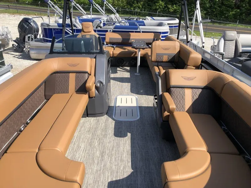 Slide: The Image of 2025 Bennington M L-Bench 22ML pontoon boat with luxurious tan seating and modern design. - 2