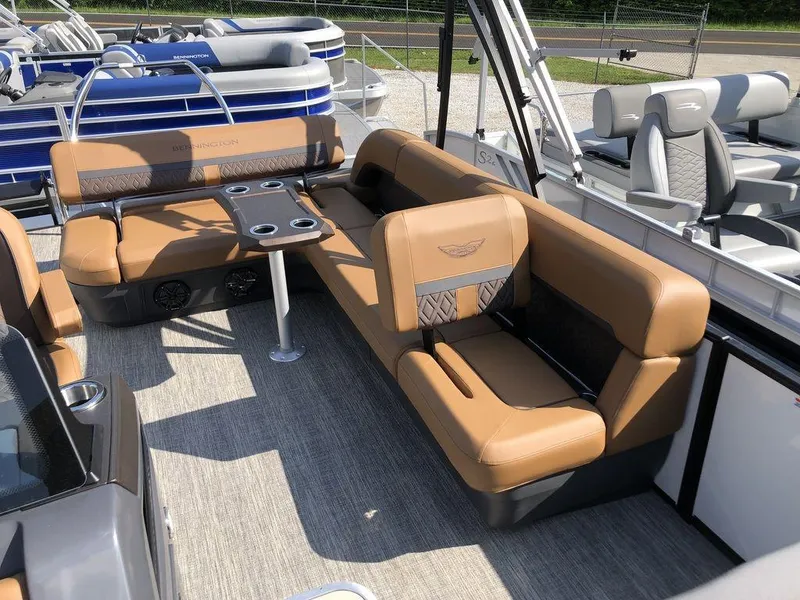 Slide: The Image of 2025 Bennington M L-Bench 22ML pontoon boat with tan seating and table. - 3