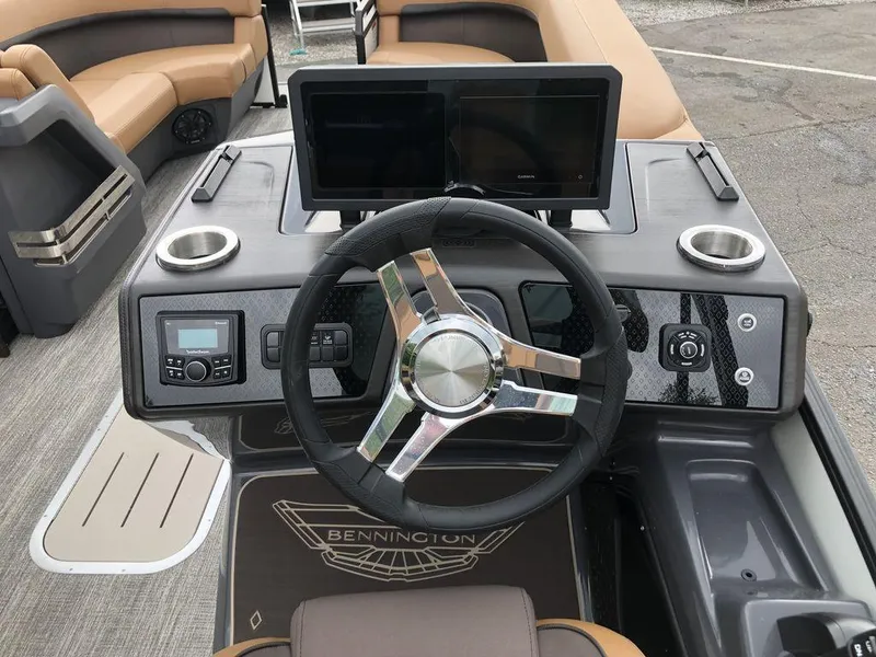 Slide: The Image of 2025 Bennington M L-Bench 22ML boat dashboard with dual screens and steering wheel. - 5