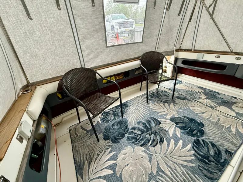 Slide: The Image of 1989 Sea Ray 340 Sundancer interior with chairs and tropical rug. - 11