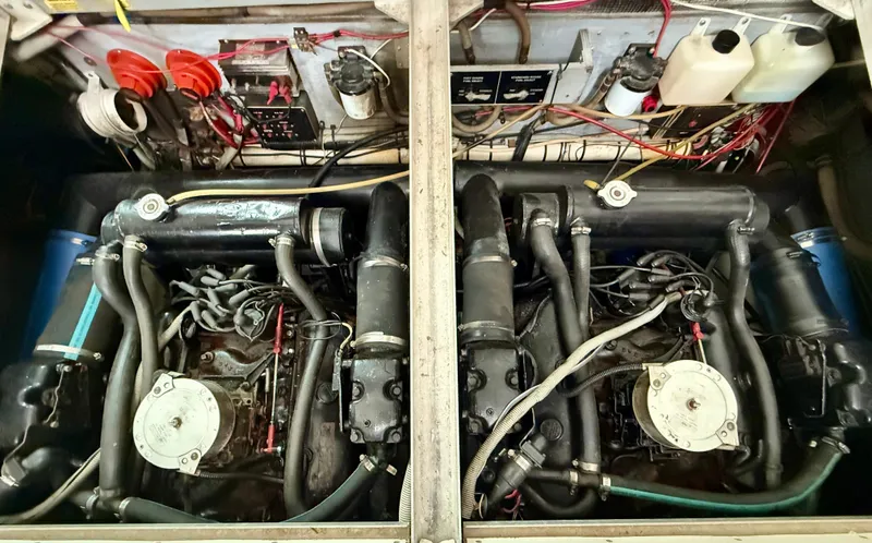 Slide: The Image of Engine compartment of a 1989 Sea Ray 340 Sundancer, showcasing dual engines and wiring. - 12