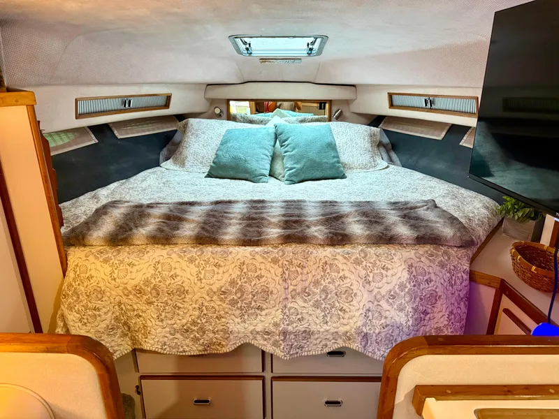 Slide: The Image of Cozy cabin interior of 1989 Sea Ray 340 Sundancer with bed and pillows. - 4