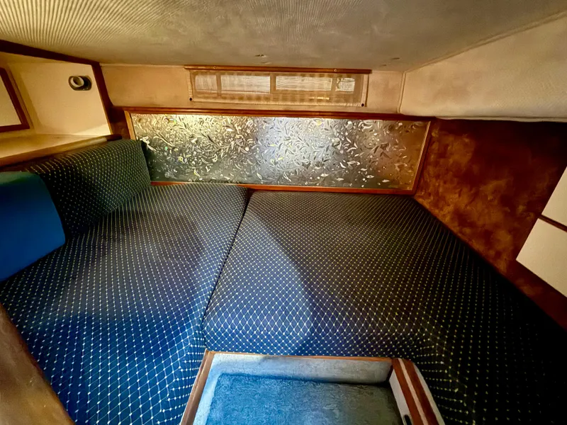 Slide: The Image of 1989 Sea Ray 340 Sundancer cabin interior with patterned upholstery and textured wall panel. - 5