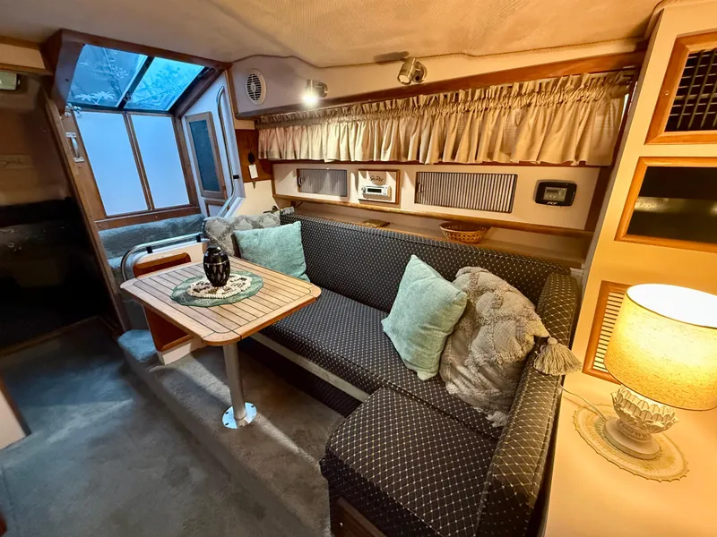 Slide: The Image of 1989 Sea Ray 340 Sundancer cabin interior with cozy seating and elegant decor. - 7
