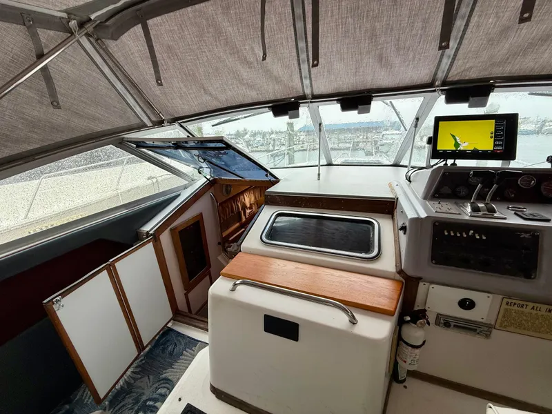 Slide: The Image of 1989 Sea Ray 340 Sundancer helm with navigation equipment and covered cockpit. - 9