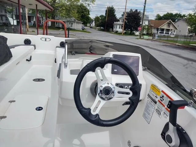 Slide: The Image of 2024 Tahoe T18 boat interior with steering wheel and dashboard controls. - 6