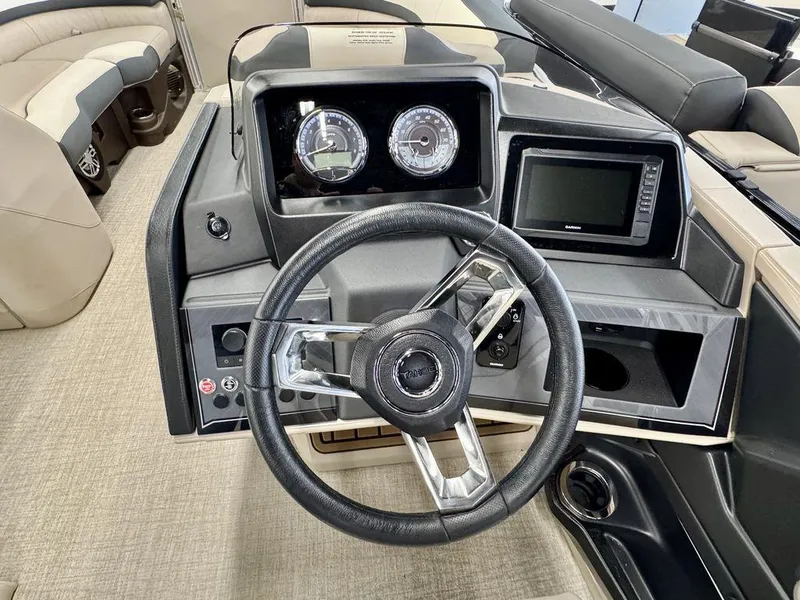 Slide: The Image of Steering console of 2025 Tahoe Cascade 2385 QLS boat with gauges and navigation screen. - 14
