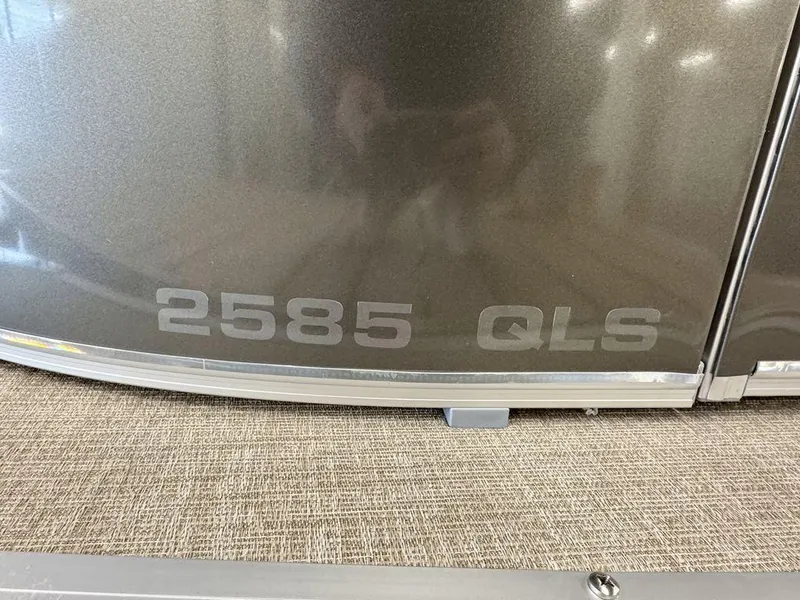 Slide: The Image of 2025 Tahoe Cascade 2385 QLS boat, close-up of model number "2585 QLS" on metallic surface. - 5