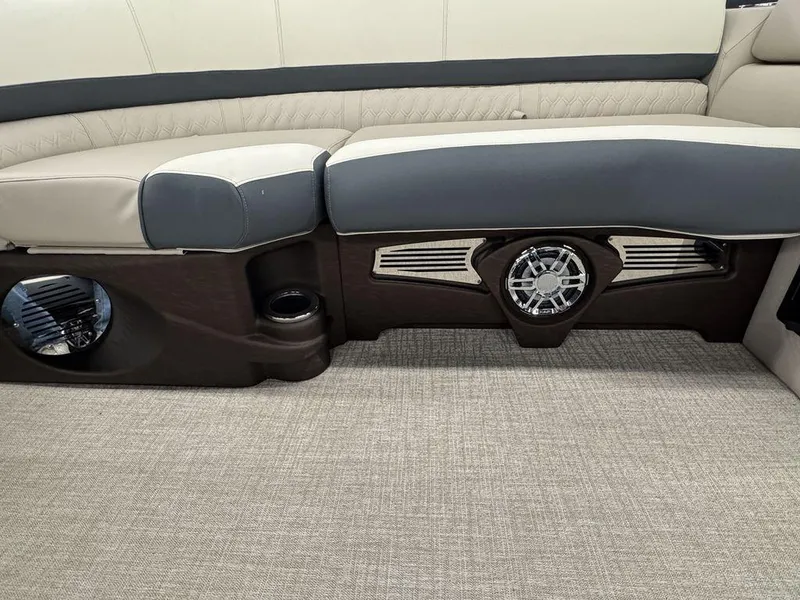 Slide: The Image of 2025 Tahoe Cascade 2385 QLS interior seating with speaker and cup holder. - 7