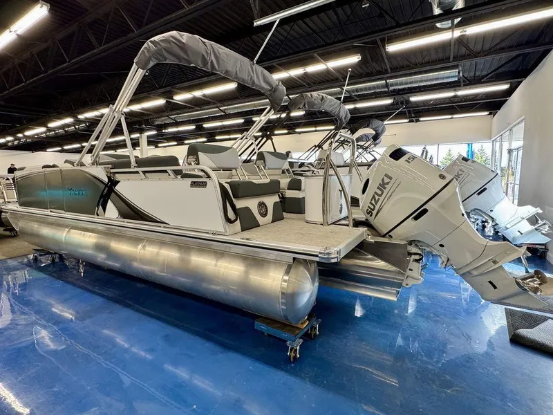 Slide: The Image of 2025 Tahoe LTZ 2385 QLS pontoon boat with Suzuki outboard motors in showroom. - 10