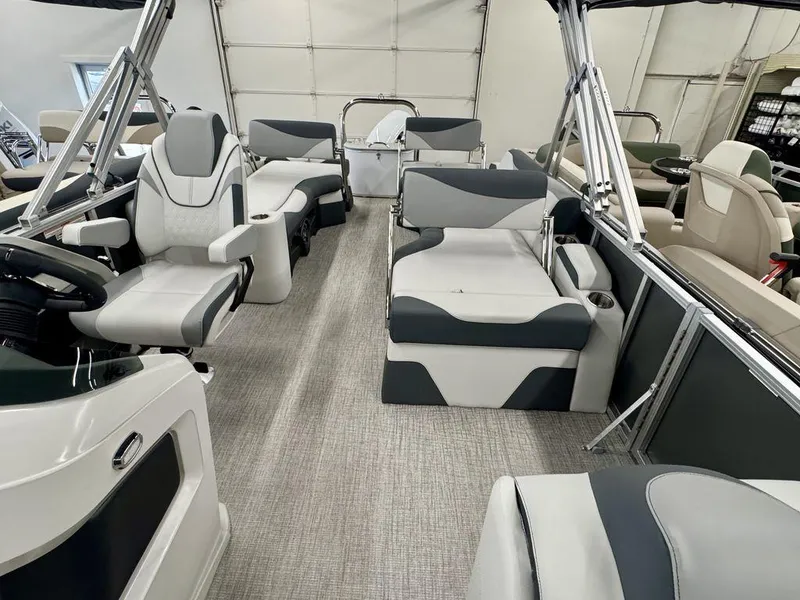 Slide: The Image of 2025 Tahoe LTZ 2385 QLS pontoon boat interior with modern seating and steering console. - 3