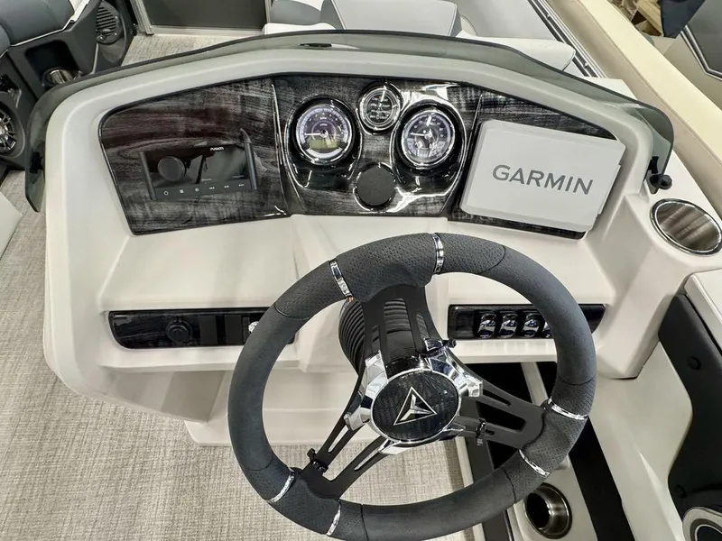 Slide: The Image of 2025 Tahoe LTZ 2385 QLS boat dashboard with Garmin navigation and modern steering wheel. - 5