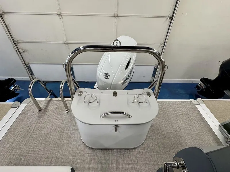 Slide: The Image of 2025 Tahoe LTZ 2385 QLS boat interior with motor and railing. - 7