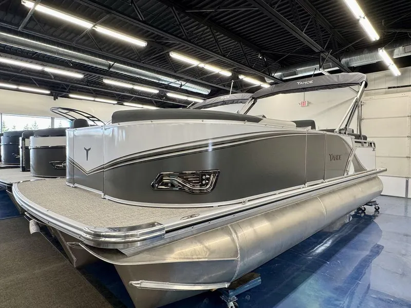 Slide: The Image of 2025 Tahoe LTZ 2385 QLS pontoon boat displayed in a showroom. - 9