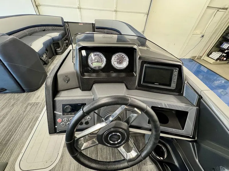 Slide: The Image of 2025 Tahoe Cascade 2585 QLS boat dashboard with steering wheel and gauges. - 10
