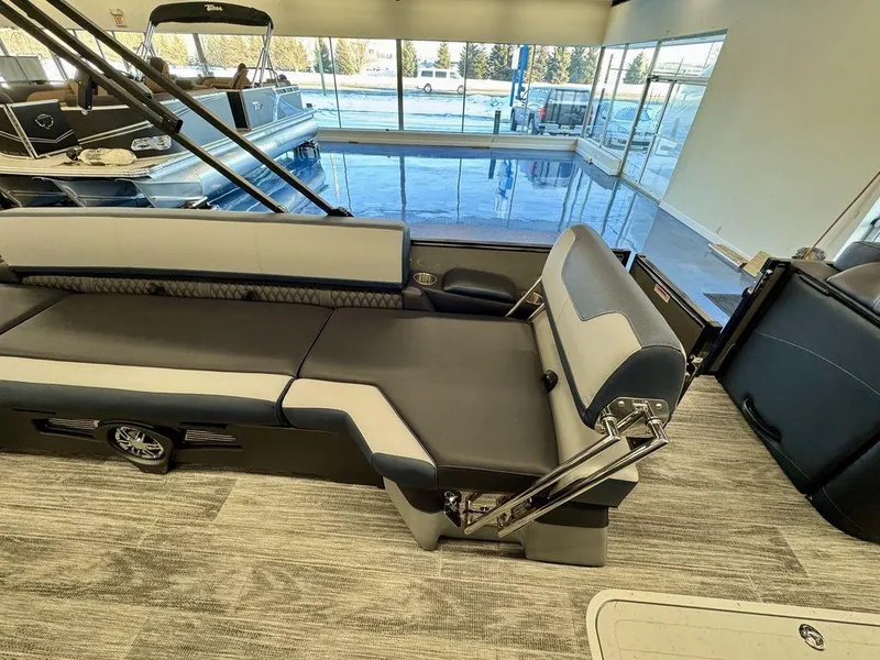 Slide: The Image of 2025 Tahoe Cascade 2585 QLS boat interior with modern seating and sleek design. - 11