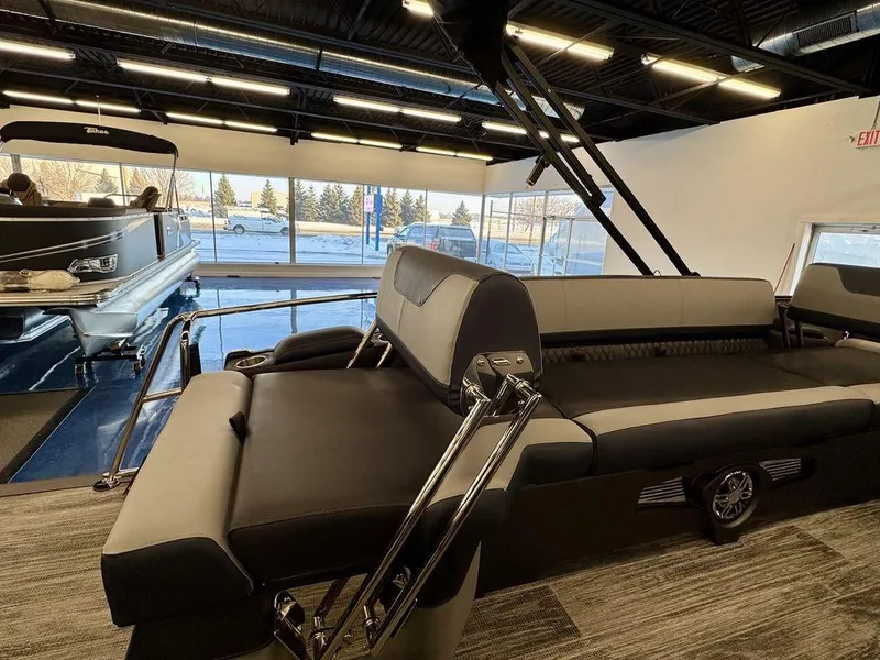 Slide: The Image of 2025 Tahoe Cascade 2585 QLS pontoon boat interior with luxurious seating in showroom. - 15