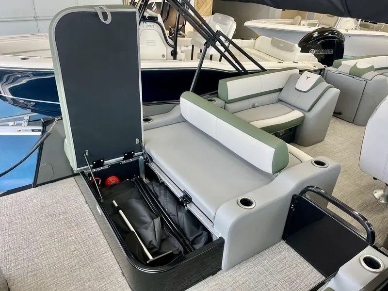 Slide: The Image of 2025 Tahoe Cascade 2385 VRB boat interior with open storage compartment and seating. - 16