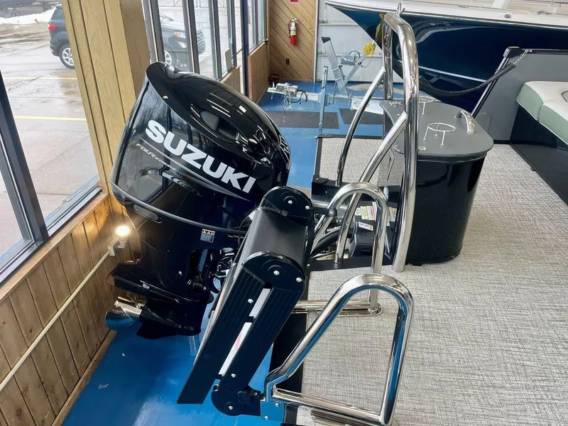 Slide: The Image of 2025 Tahoe Cascade 2385 VRB with Suzuki outboard motor in showroom. - 18