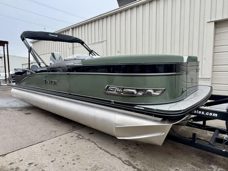 Slide: The Image of 2025 Tahoe Cascade 2385 VRB pontoon boat on trailer, sleek design, green exterior. - 3