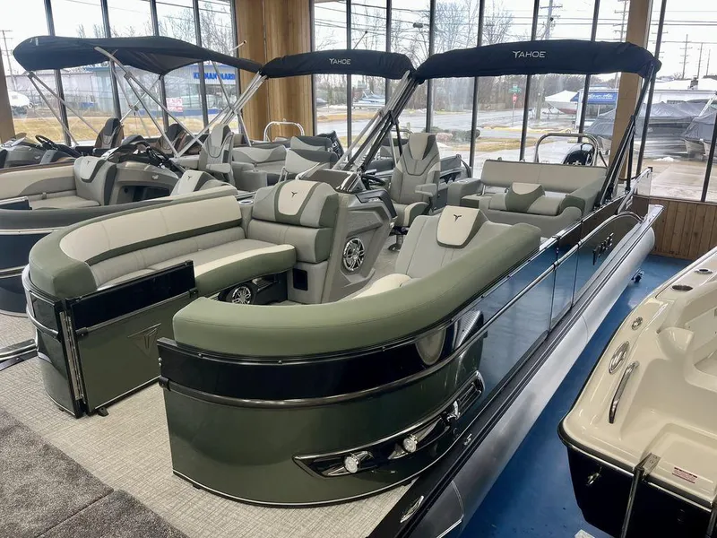 Slide: The Image of 2025 Tahoe Cascade 2385 VRB pontoon boat with sleek design and luxurious seating in showroom. - 7