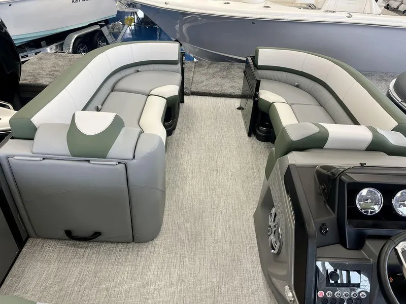 Slide: The Image of 2025 Tahoe Cascade 2385 VRB boat interior with plush seating and modern dashboard. - 9