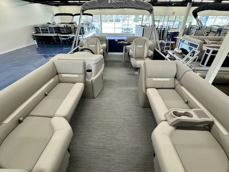 Slide: The Image of 2025 Godfrey EX 2286 SBX pontoon boat interior with beige seating and modern design. - 5