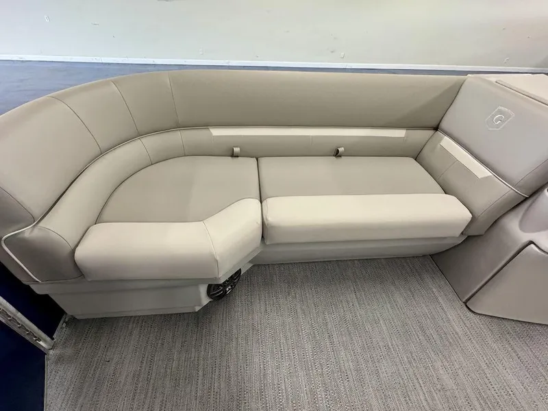 Slide: The Image of 2025 Godfrey EX 2286 SBX boat interior with beige seating and carpeted flooring. - 6
