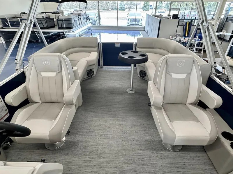 Slide: The Image of 2025 Godfrey EX 2286 SBX pontoon boat interior with plush seating and table. - 8