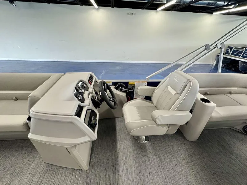 Slide: The Image of 2025 Godfrey EX 2286 SBX boat interior with modern helm and comfortable seating. - 9